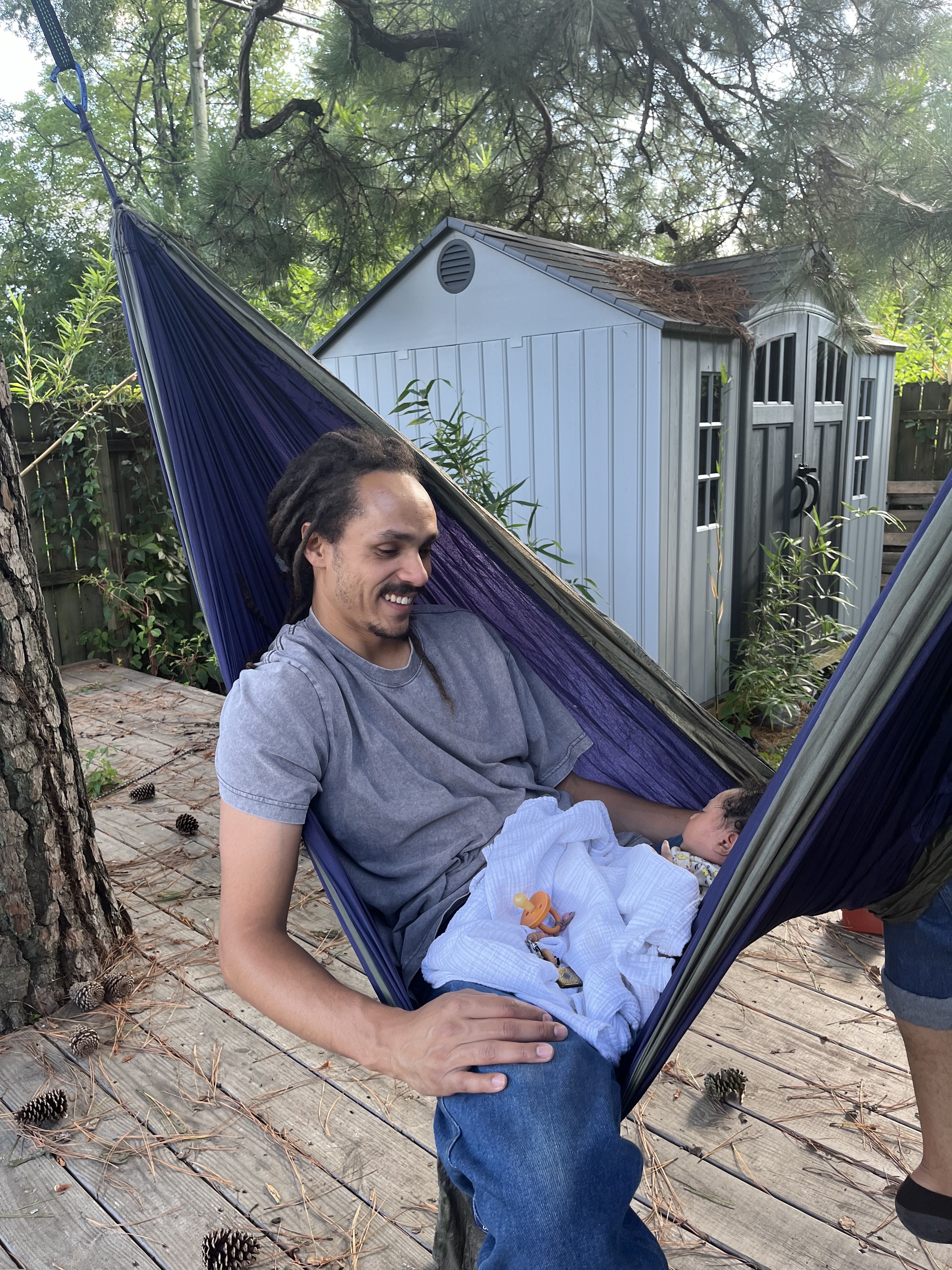 Baby & parent laying in hammock